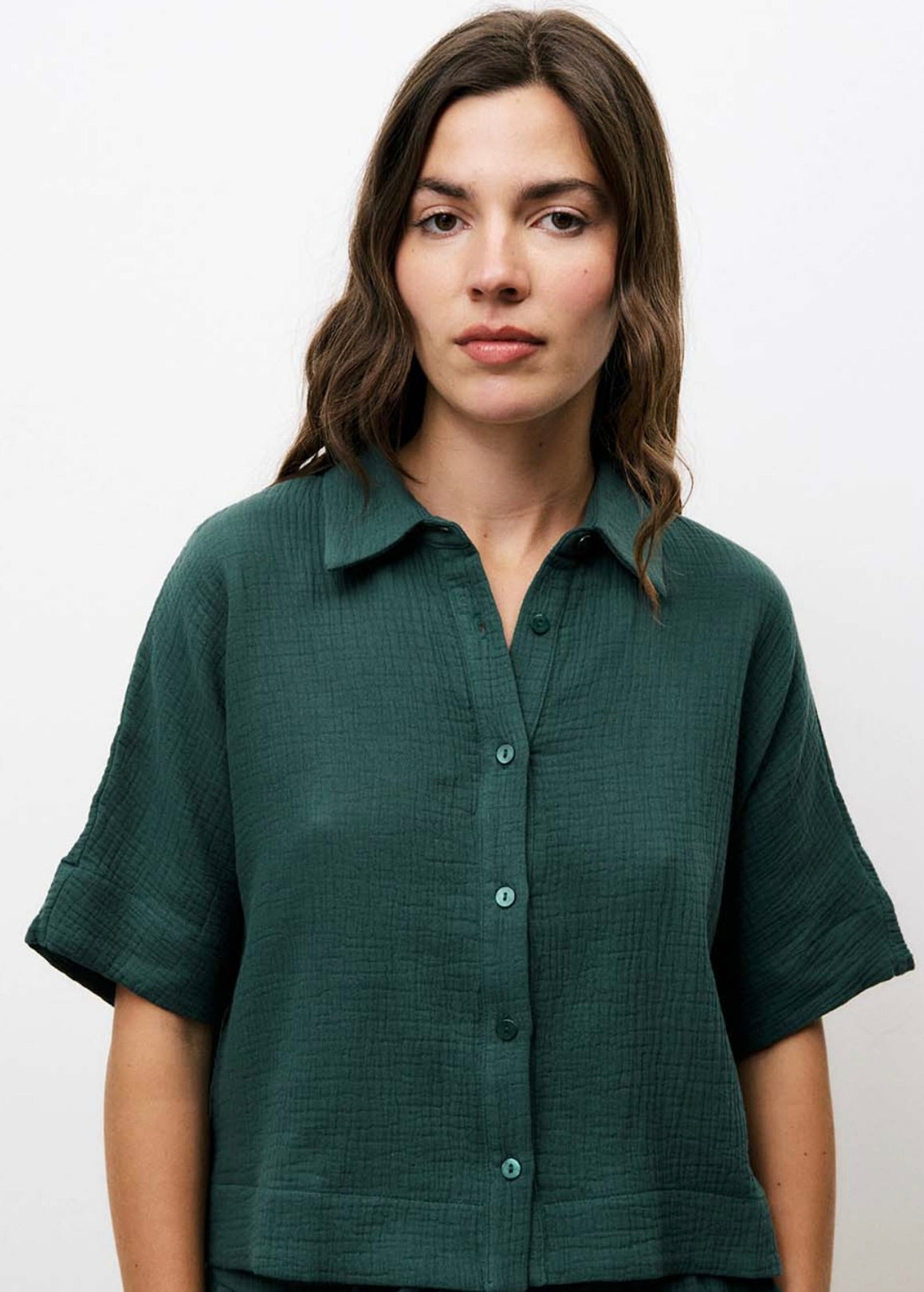 Woman wearing matching dark Forrest green, shorts and short-sleeve set