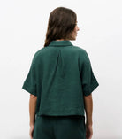 Woman wearing matching dark Forrest green, shorts and short-sleeve set