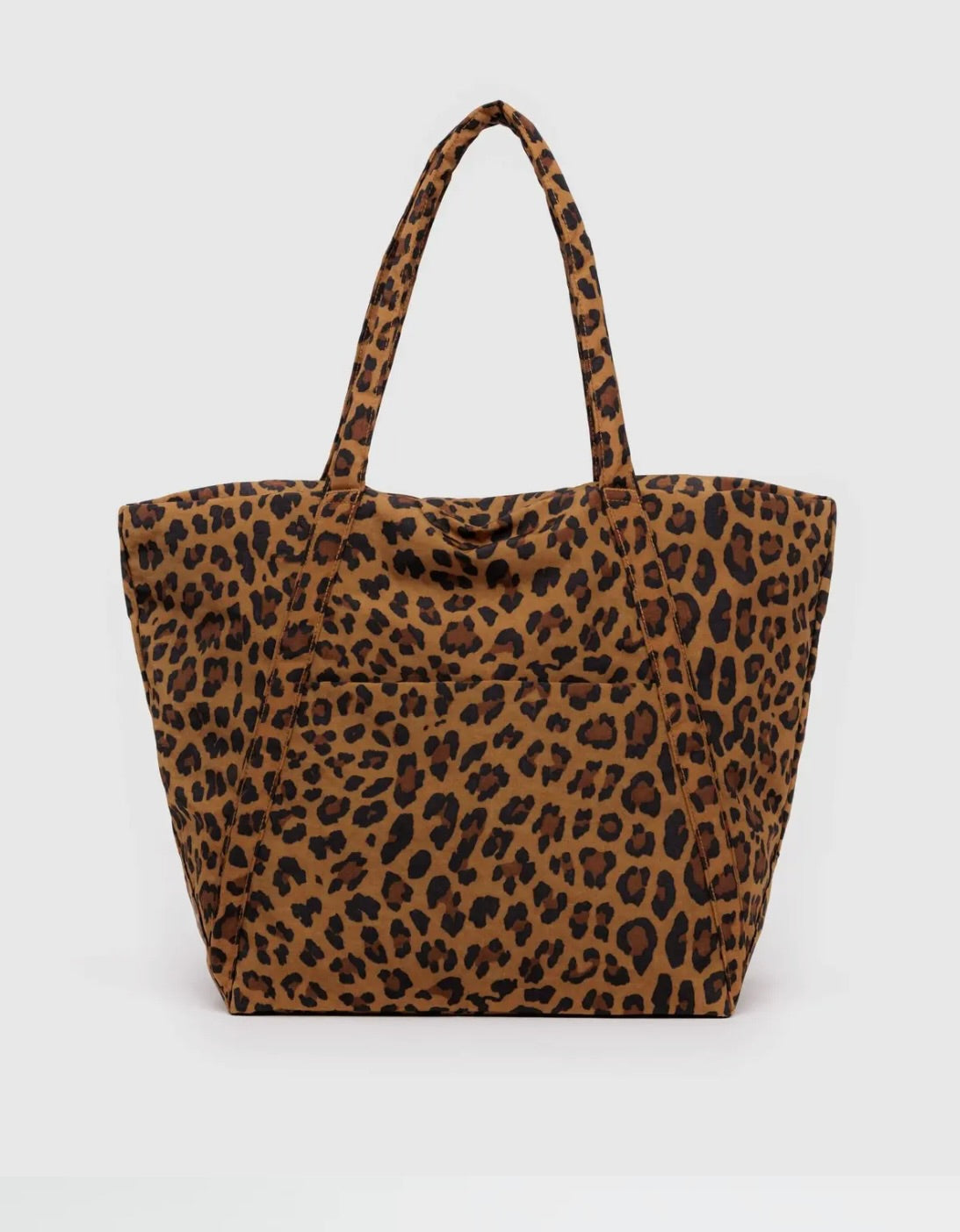Large leopard tote bag behind a white background. 