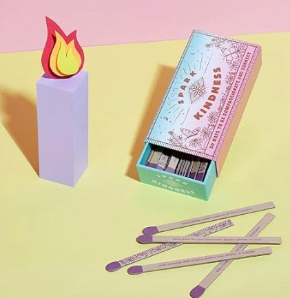 Matches with a box labeled 'Spark Kindness' on a colorful background