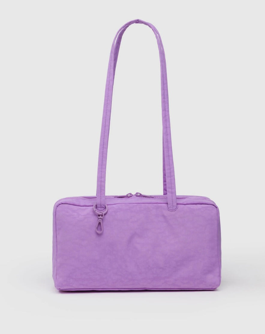 Purple lilac handbag with a long strap on a white background