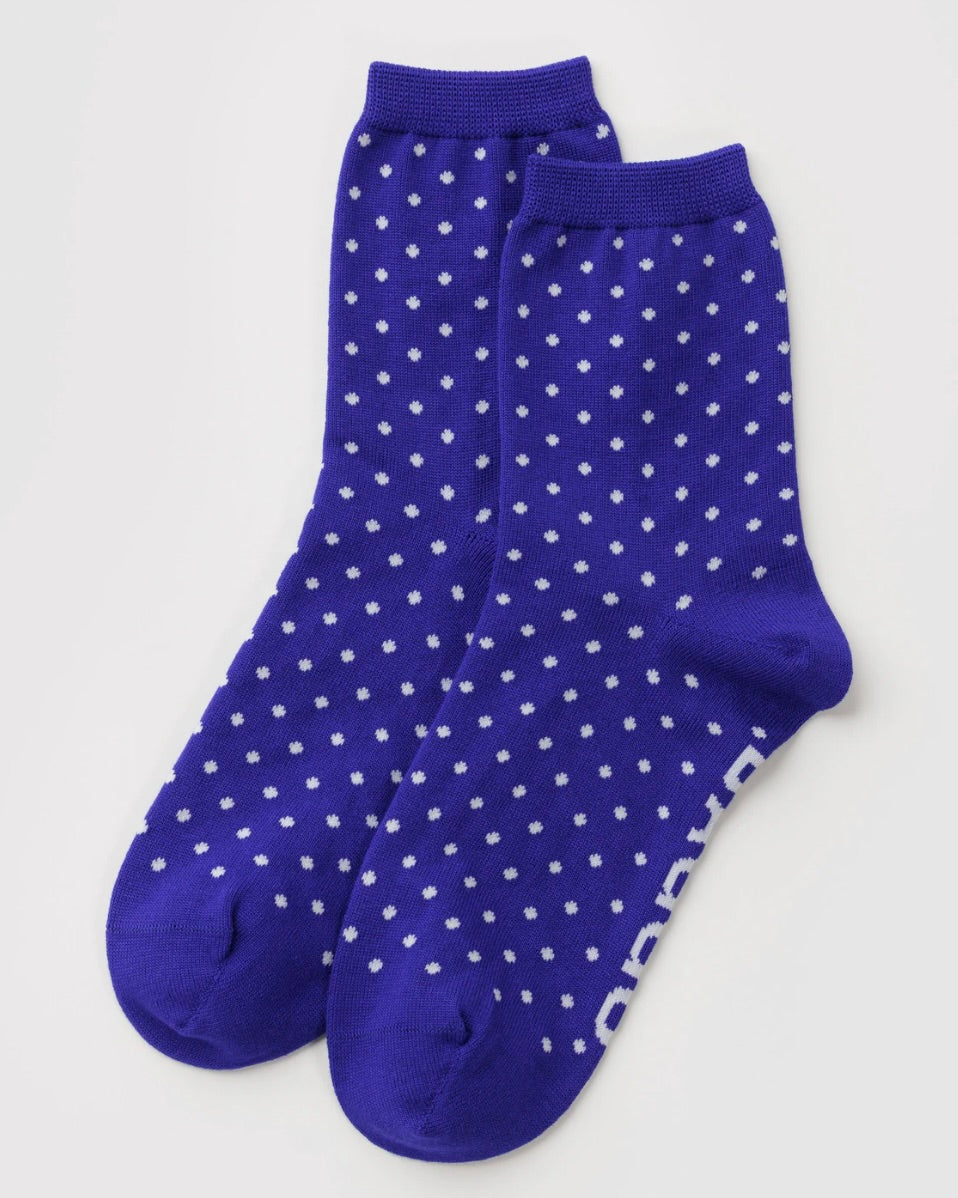 A pair of royal blue crew socks with a white geometric dot pattern, displayed on a clean light gray background.