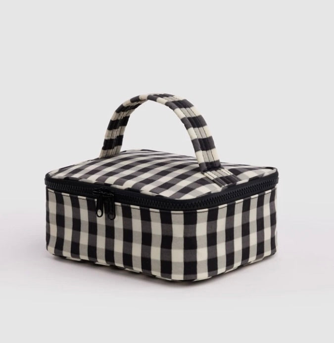 A small rectangular zippered bag with a black and off-white gingham check pattern, featuring a top handle and a black zipper, shown on a light gray background.