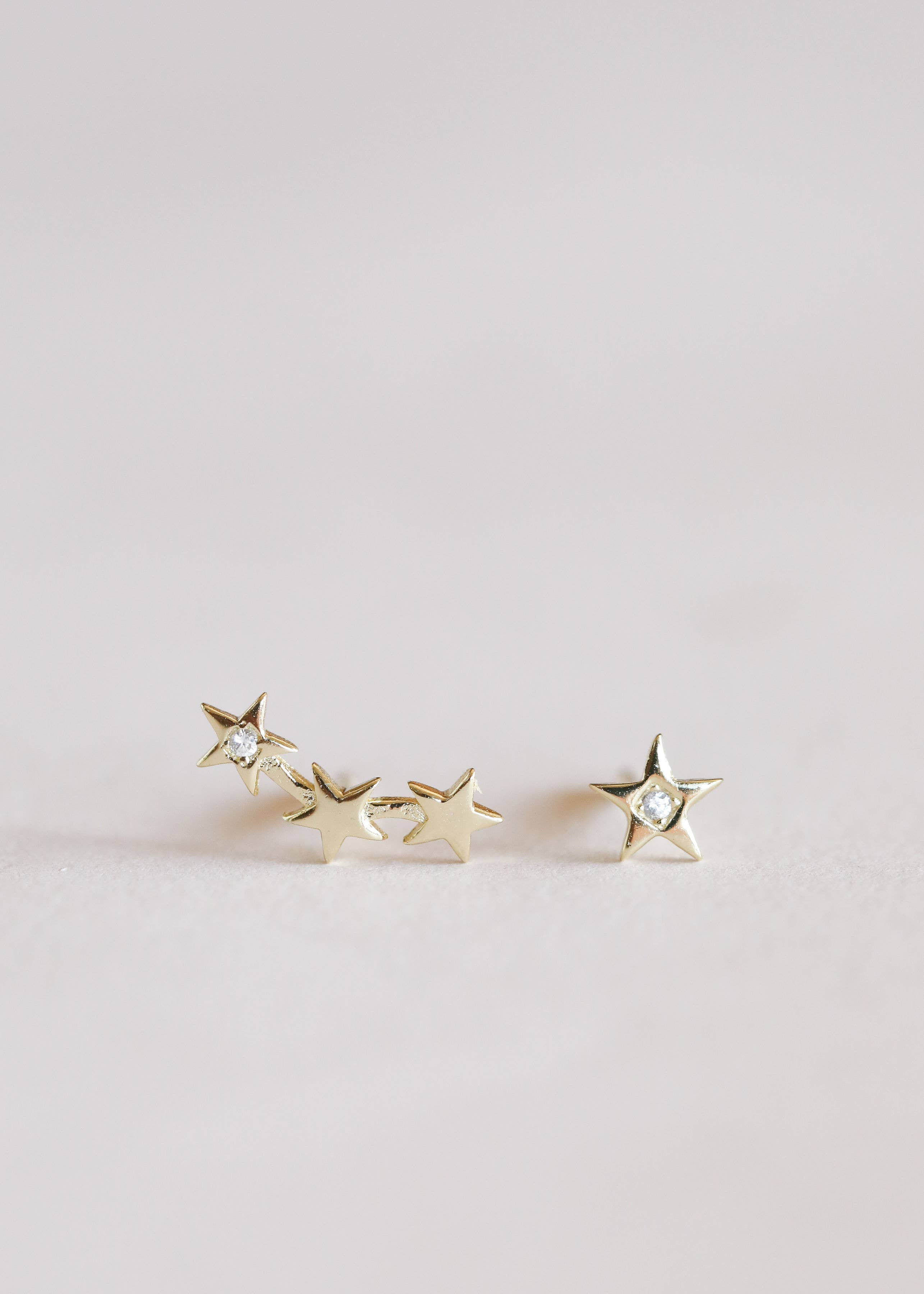Gold star-shaped earrings one side 3 stars and one side one star