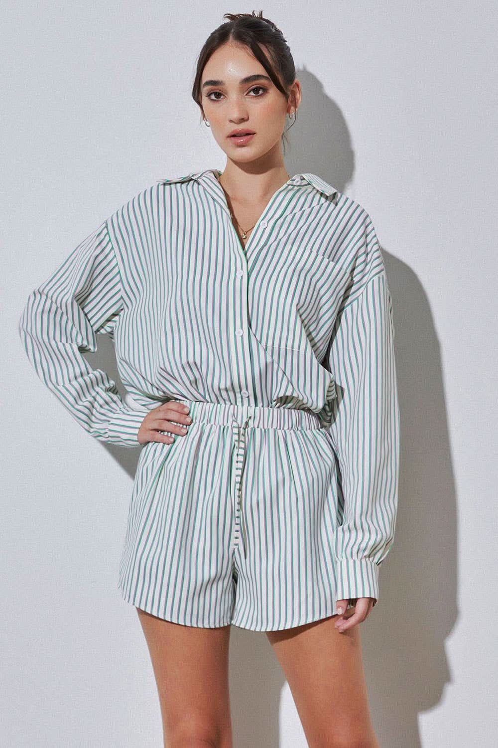 Woman wearing vertically striped green purple and blue set 