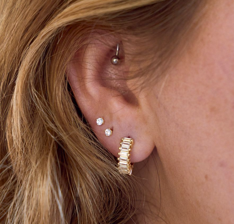Woman wearing Medium sized waterproof gold CZ hoop earrings