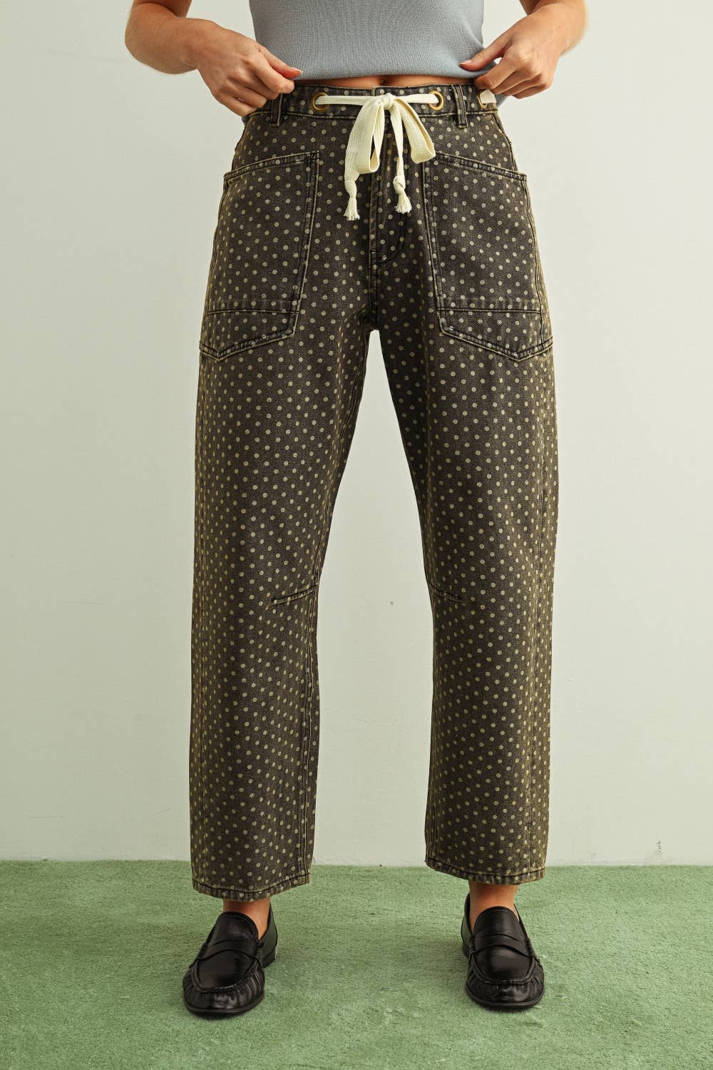 Person wearing patterned pants with a plain background
