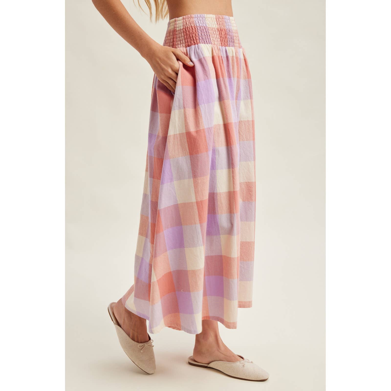 Pastel plaid skirt worn by a person on a plain background