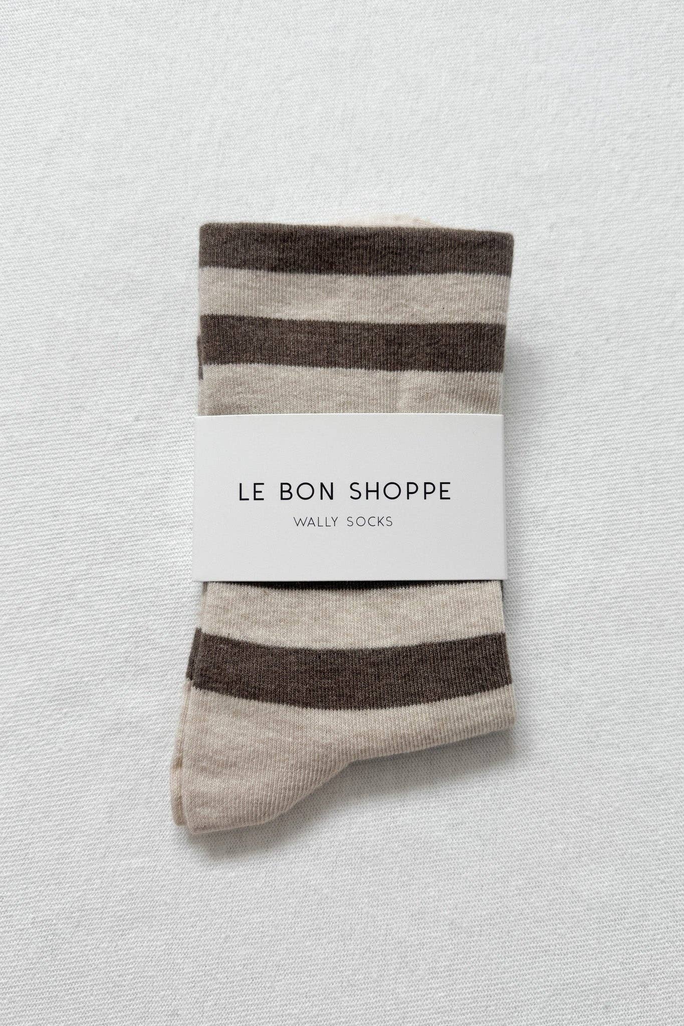 Striped socks with 'Le Bon Shoppe' label on a textured white background