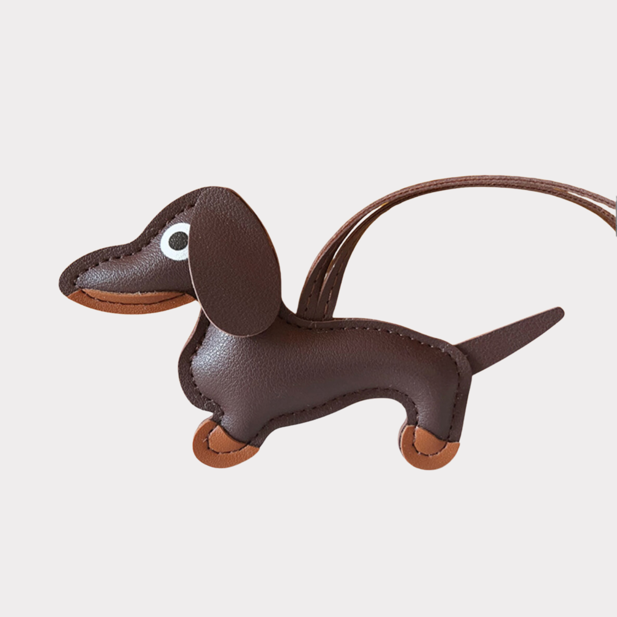 A Dachshund Leather Bag Charm in espresso brown with light brown details 