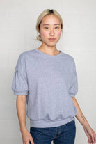 Woman wearing natural grey, short sleeve, puff sleeve, blouse t-shirt top 
