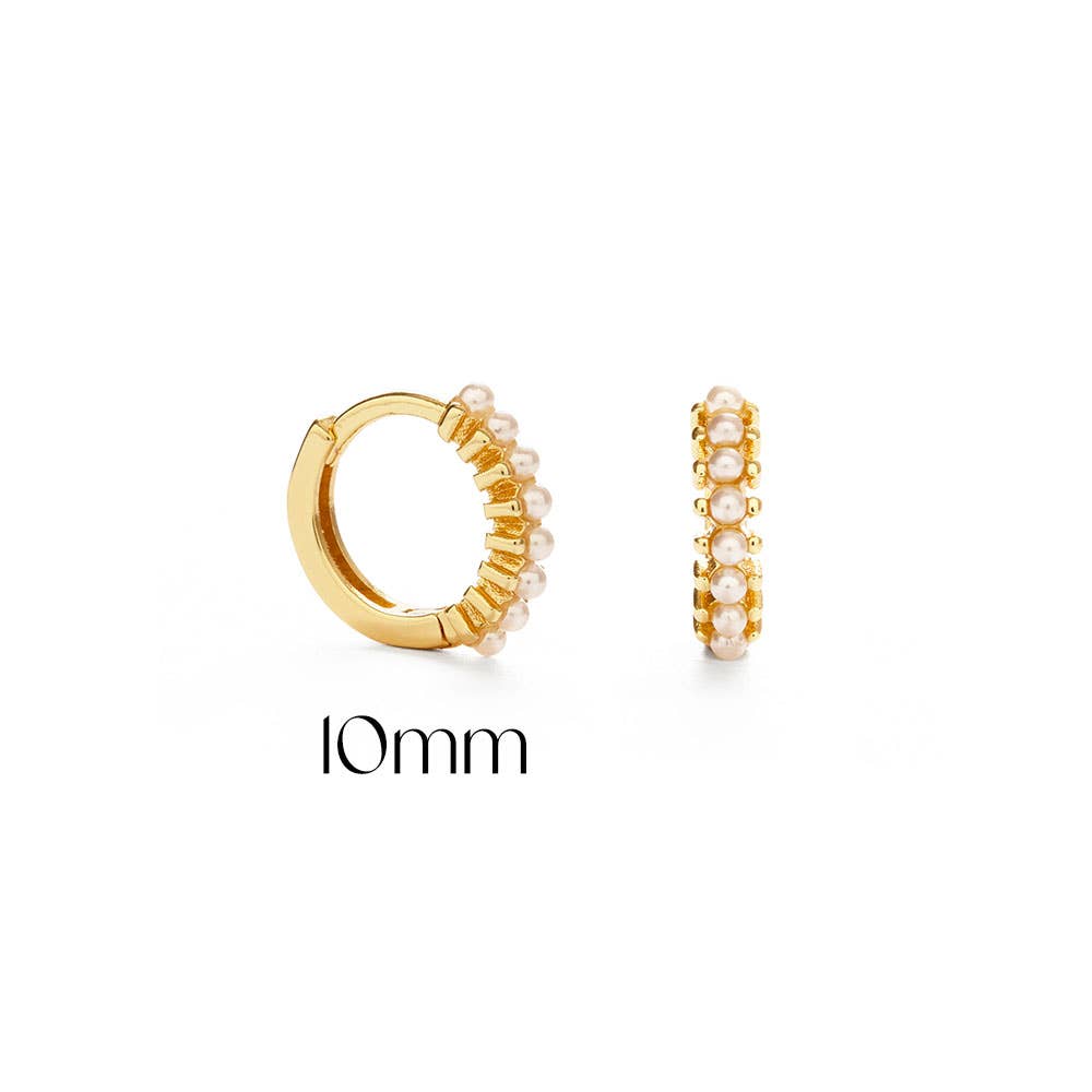 Gold hoop earrings with pearl accents on a white background