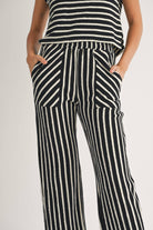 close up of woman wearing Textured vertical Stripe Knitted Pants with contrasting stripes in the front pockets made of 100% Cotton