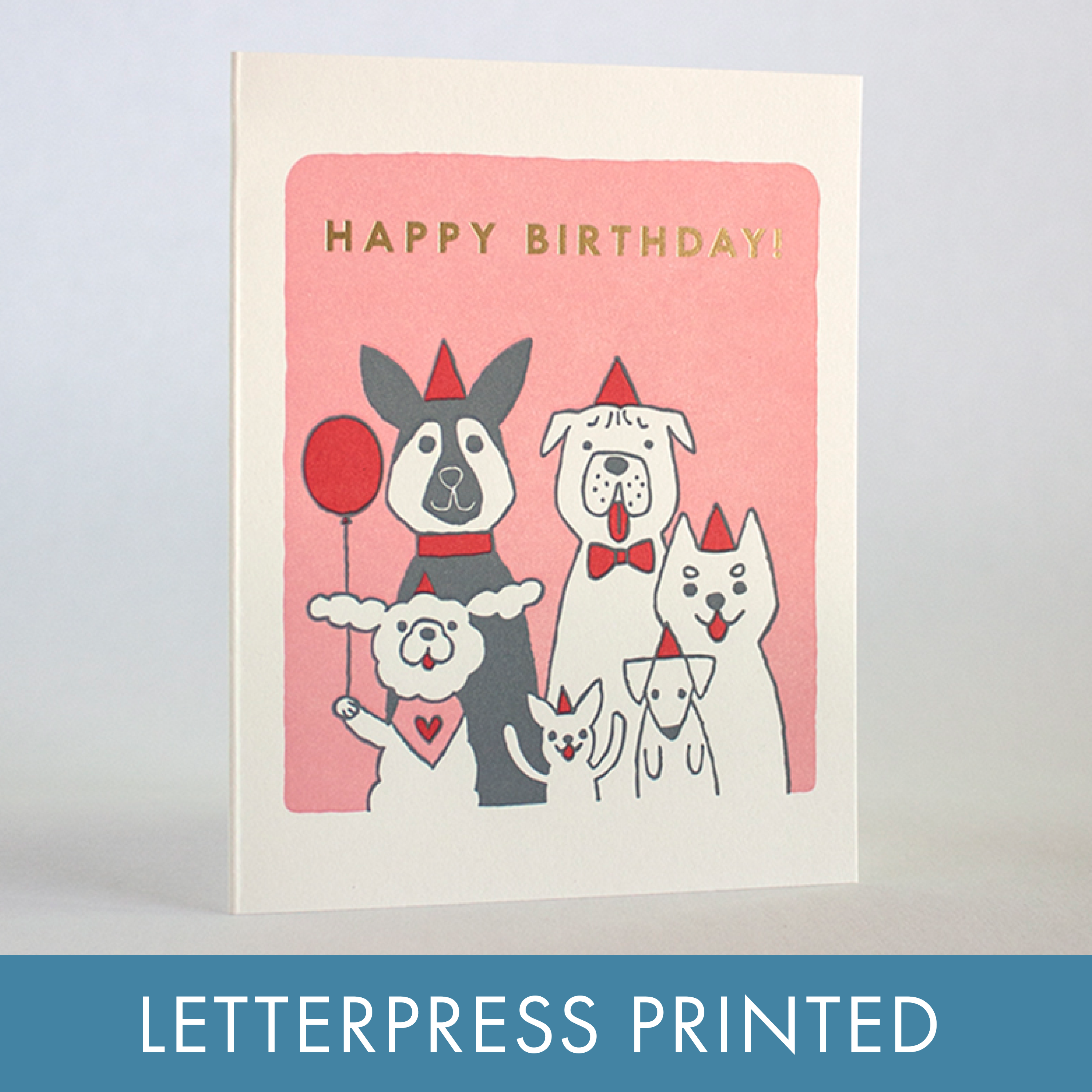 Birthday card with cartoon dogs and 'Happy Birthday!' text on a pink background