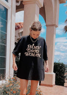 girl wearing hand printed "damn good woman" entirely cotton t-shirt 