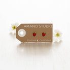 Strawberry stud earrings shown on display card 