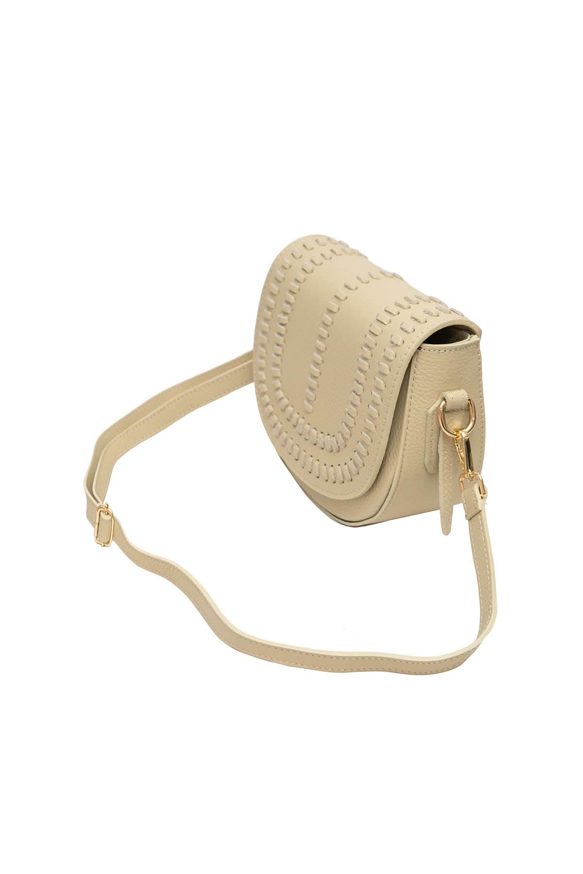Cream colored leather crossbody bag with magnetic front clap and leather woven geometric design and gold Metal details 