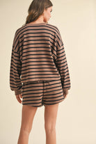 back view woman wearing black and brown striped, cozy warm and stylish design