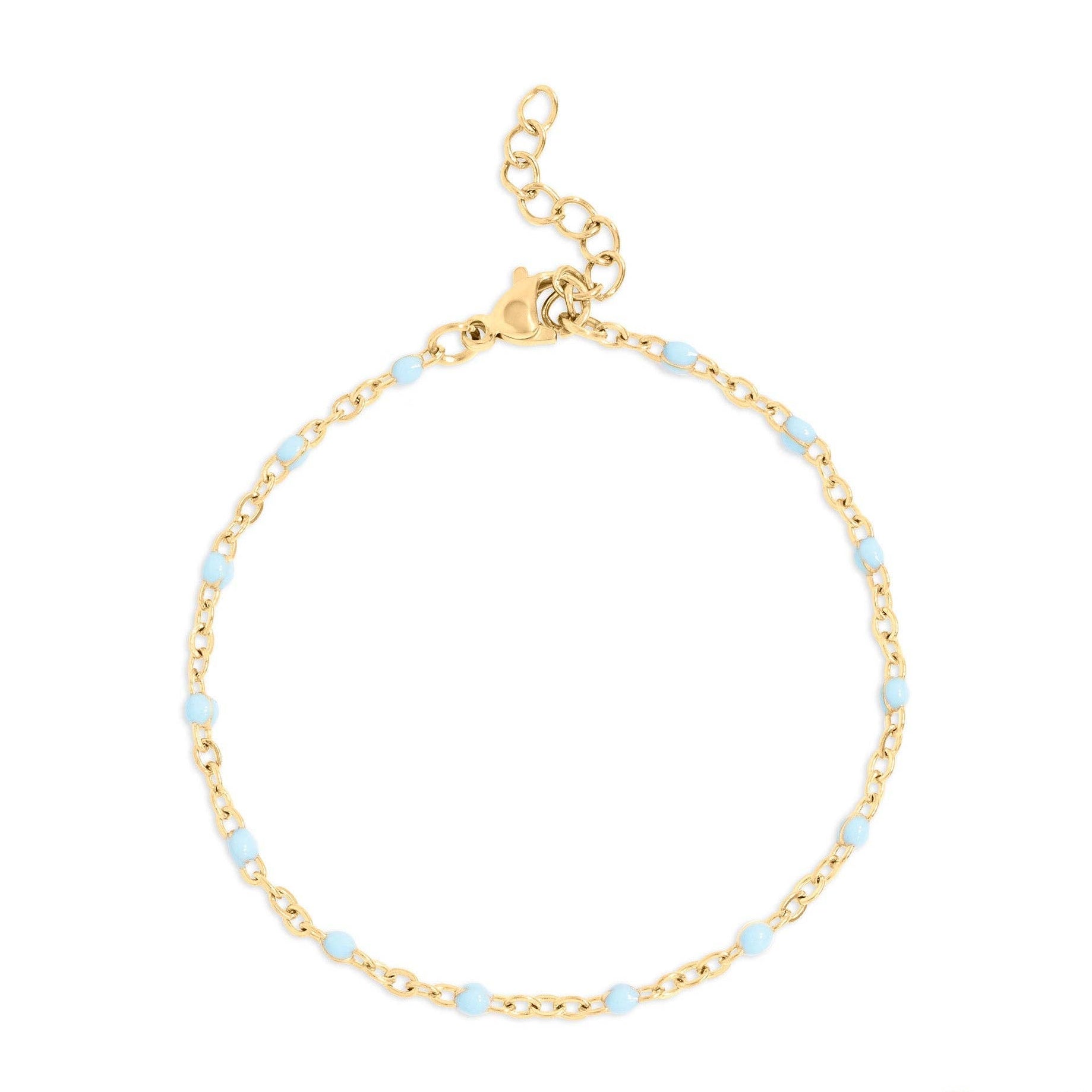 Gold bracelet with small blue beads on a white background