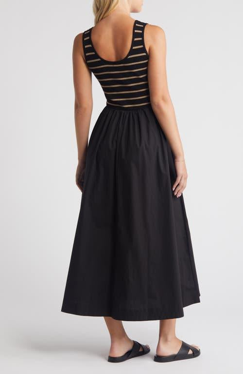 Woman wearing a black dress with a striped top on a white background