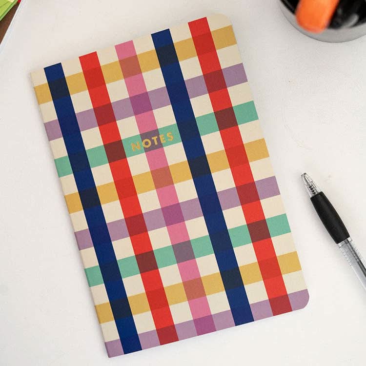 Colorful plaid notebook with the word “notes” in gold print 