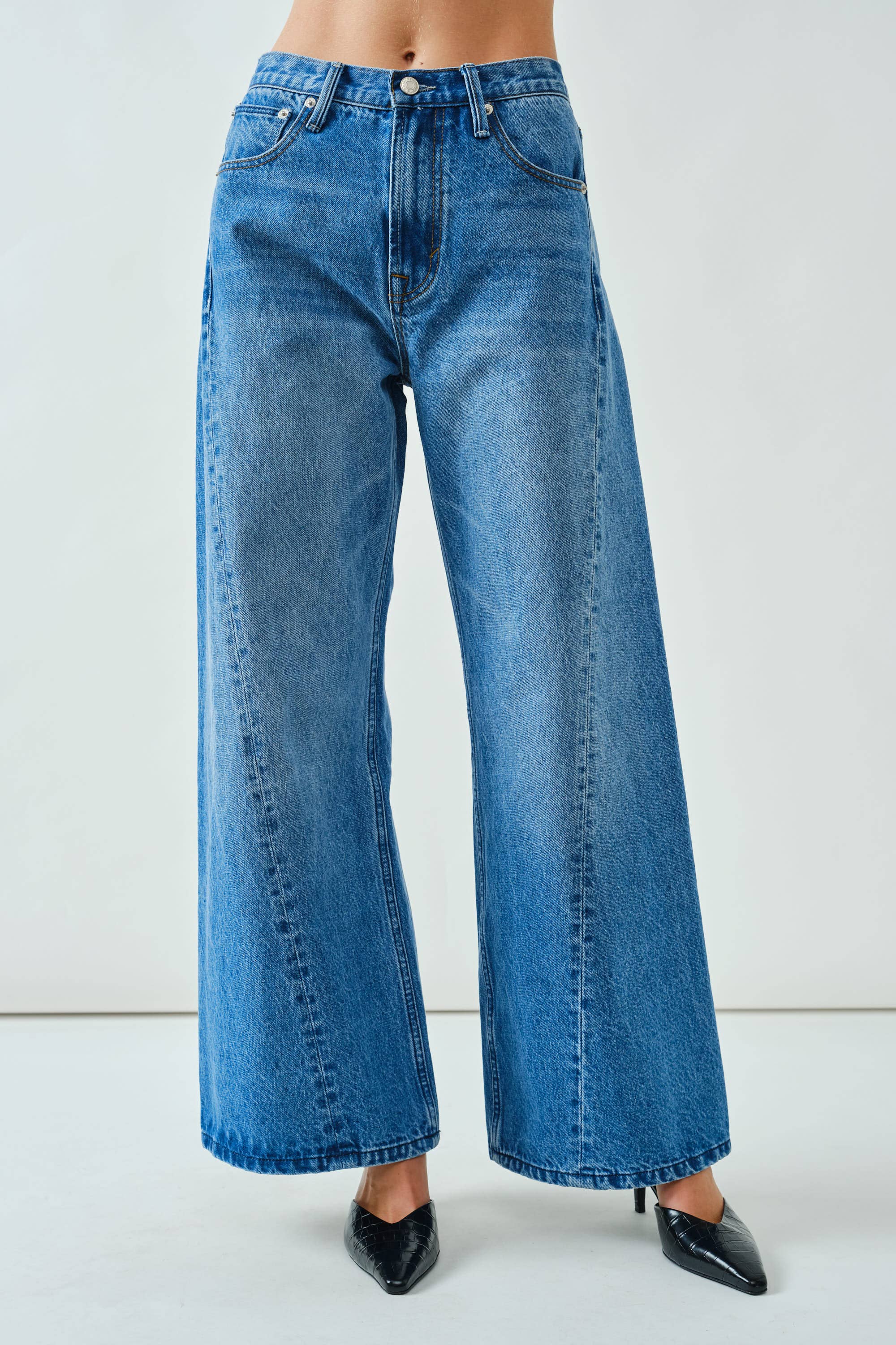 Blue jeans worn by a person on a white background