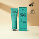 Deodorant balm in Aqua green metal tube standing upright next to Aqua packaging box 