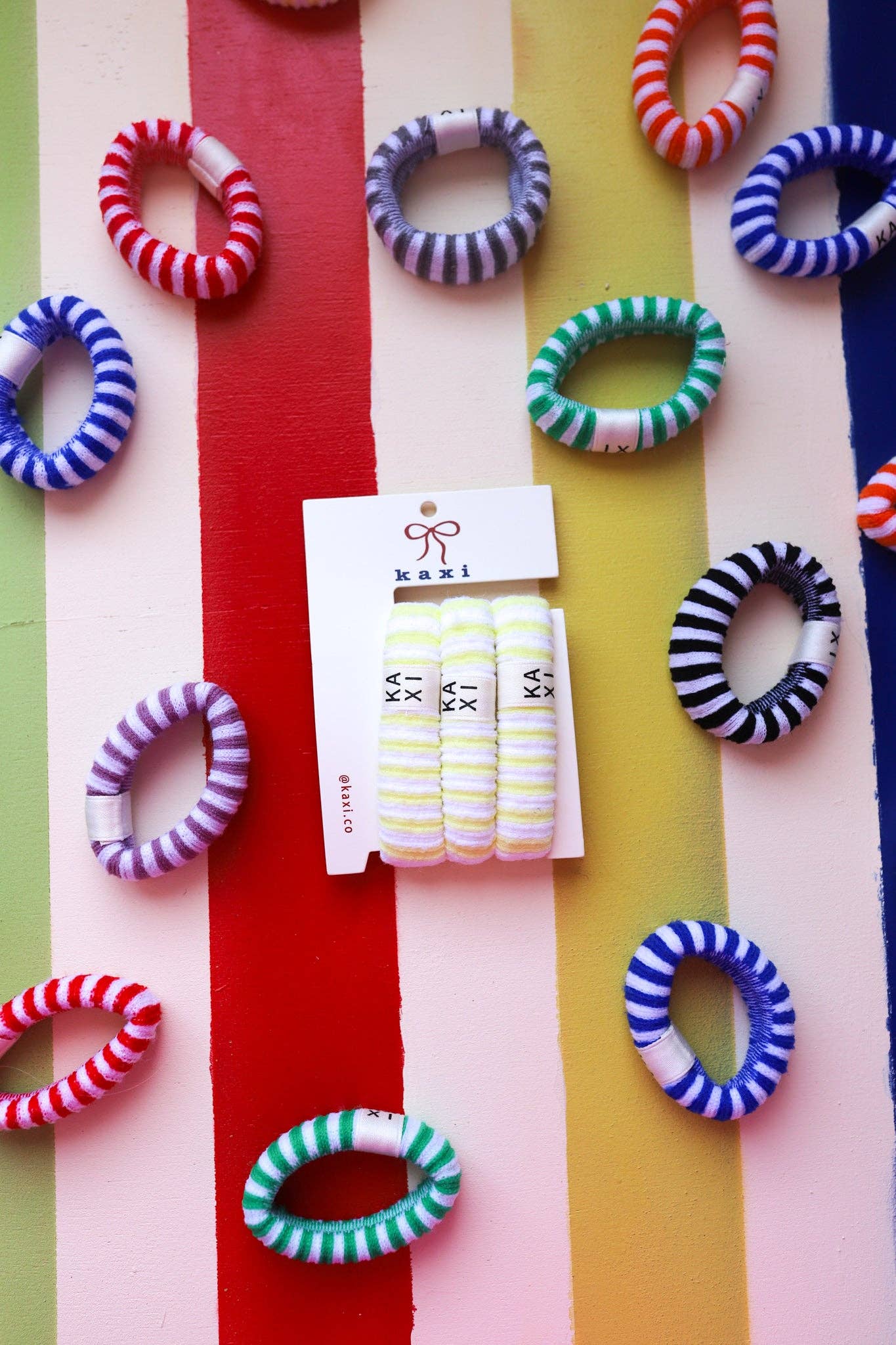 Colorful striped hair ties on a multicolored striped background