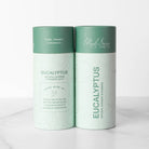 Front and back of Eucalyptus shower table packaging sitting on marble table 