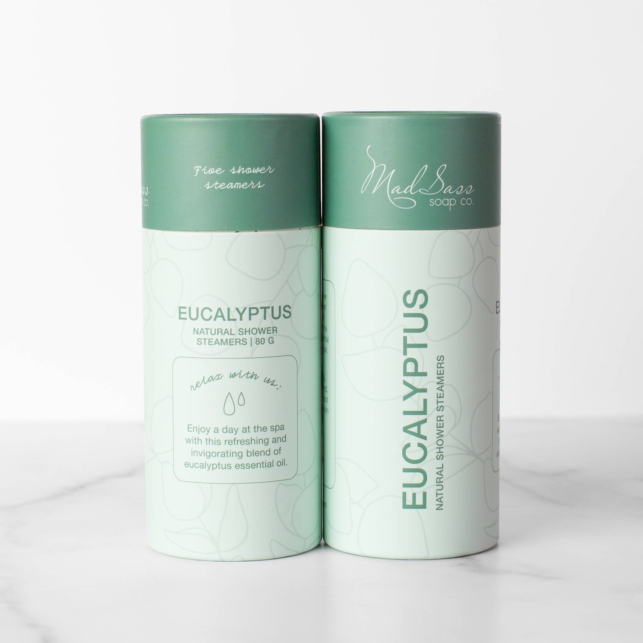 Front and back of Eucalyptus shower table packaging sitting on marble table 