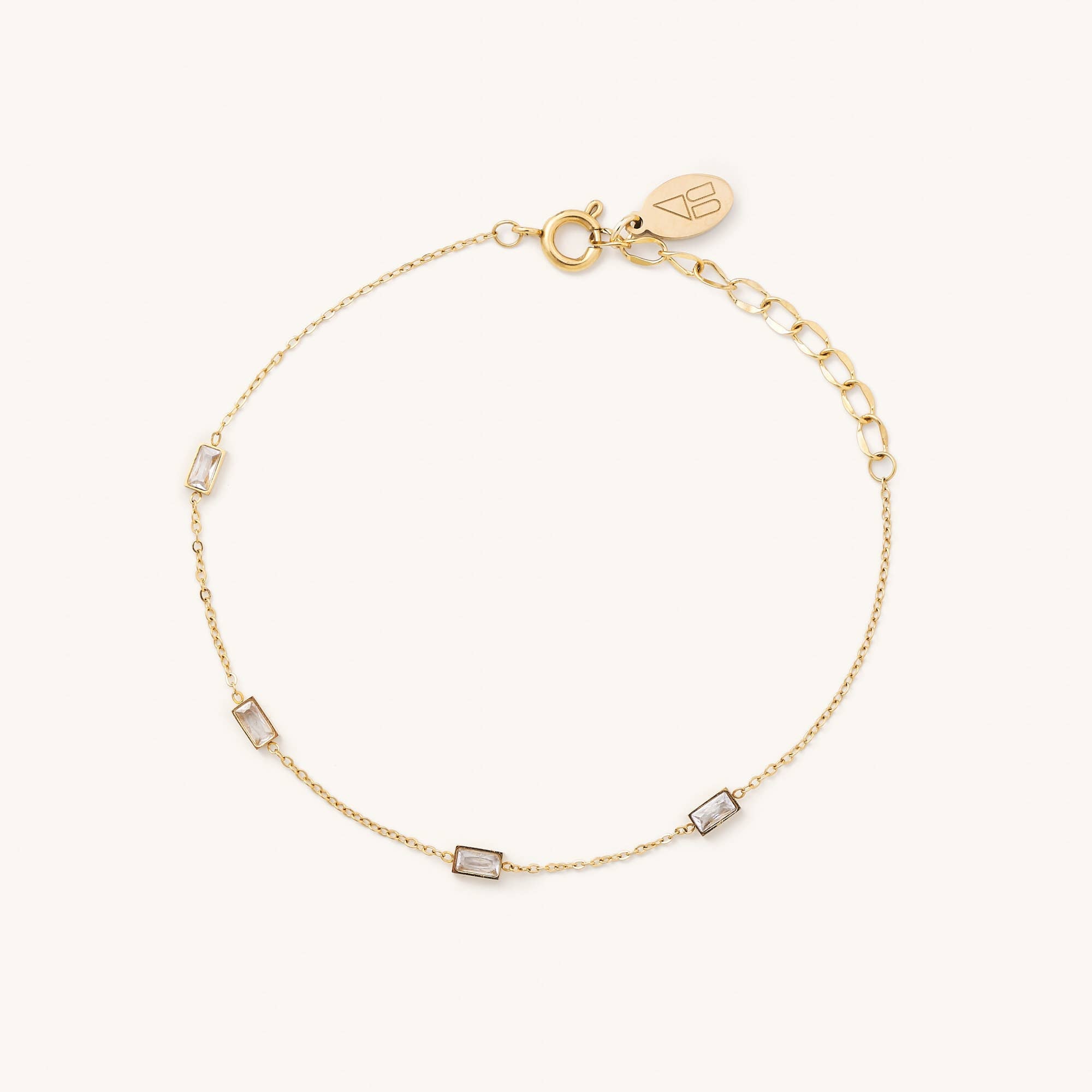 Gold chain bracelet with four rectangle crystals along the chain 