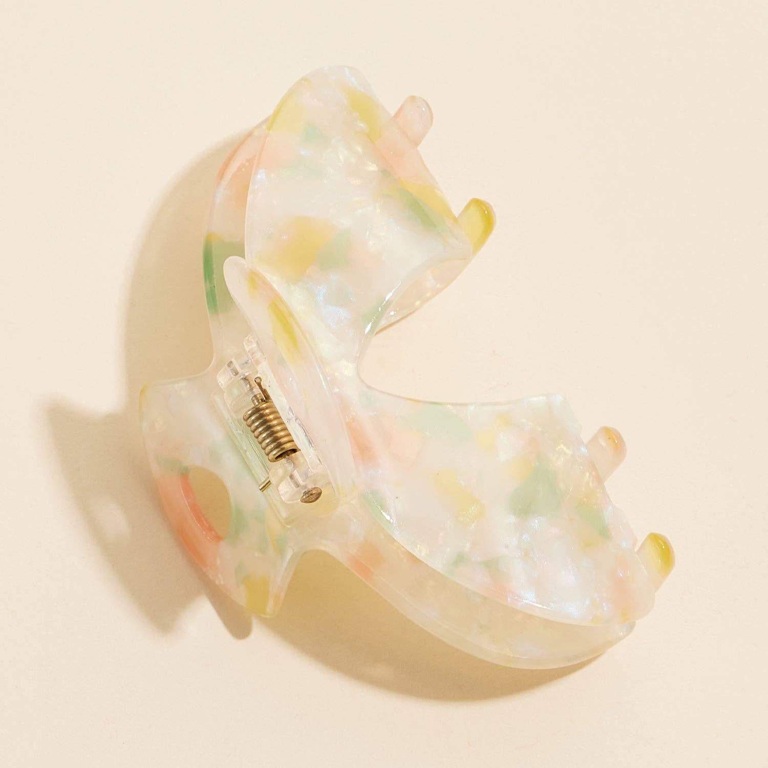 Natural colored hair claw laying on its side 