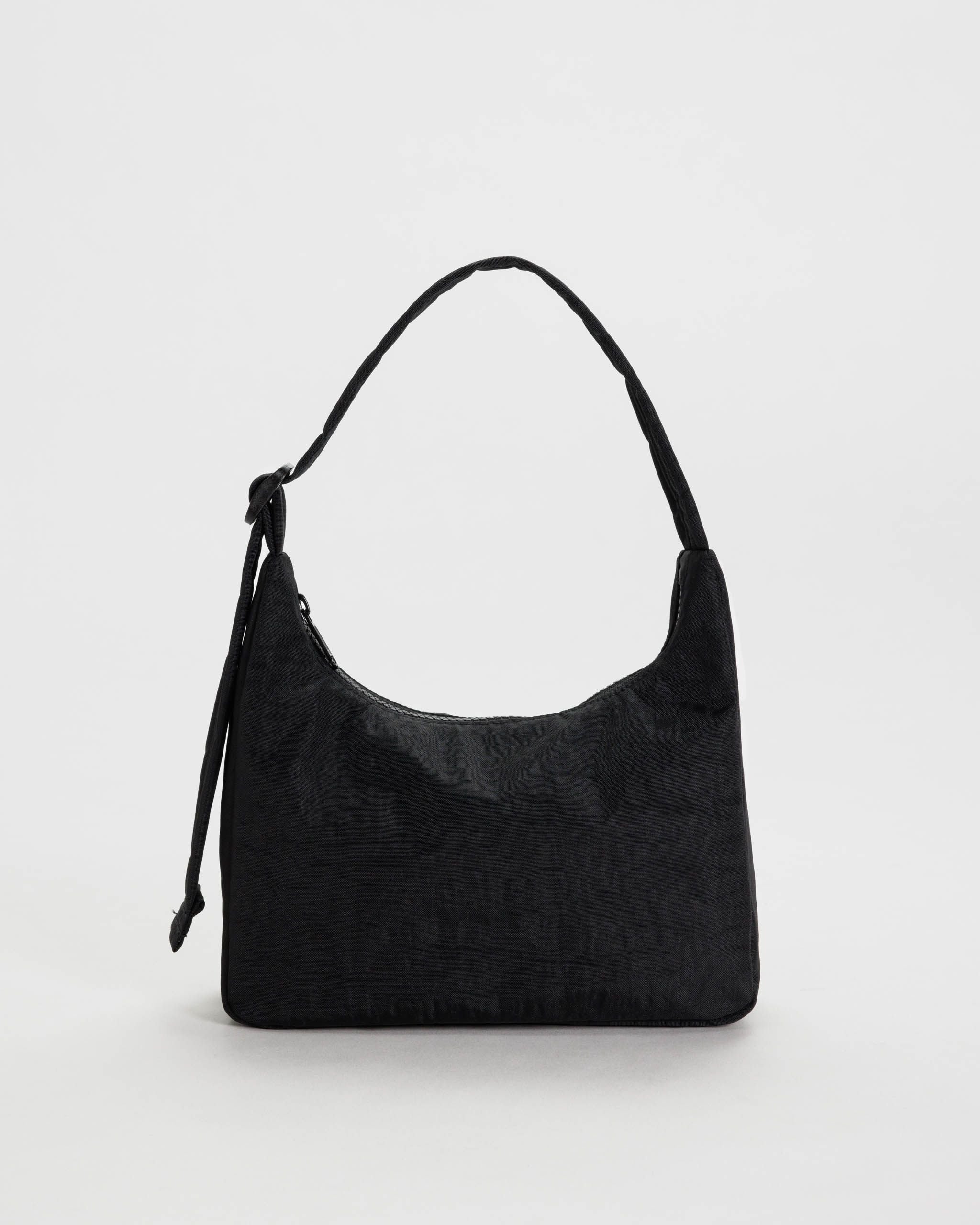 black adjustable strap nylon shoulder bag from BAGGU sitting on a white background 