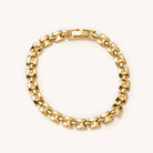 Lightweight gold watch strap bracelet laying flat on a white background 