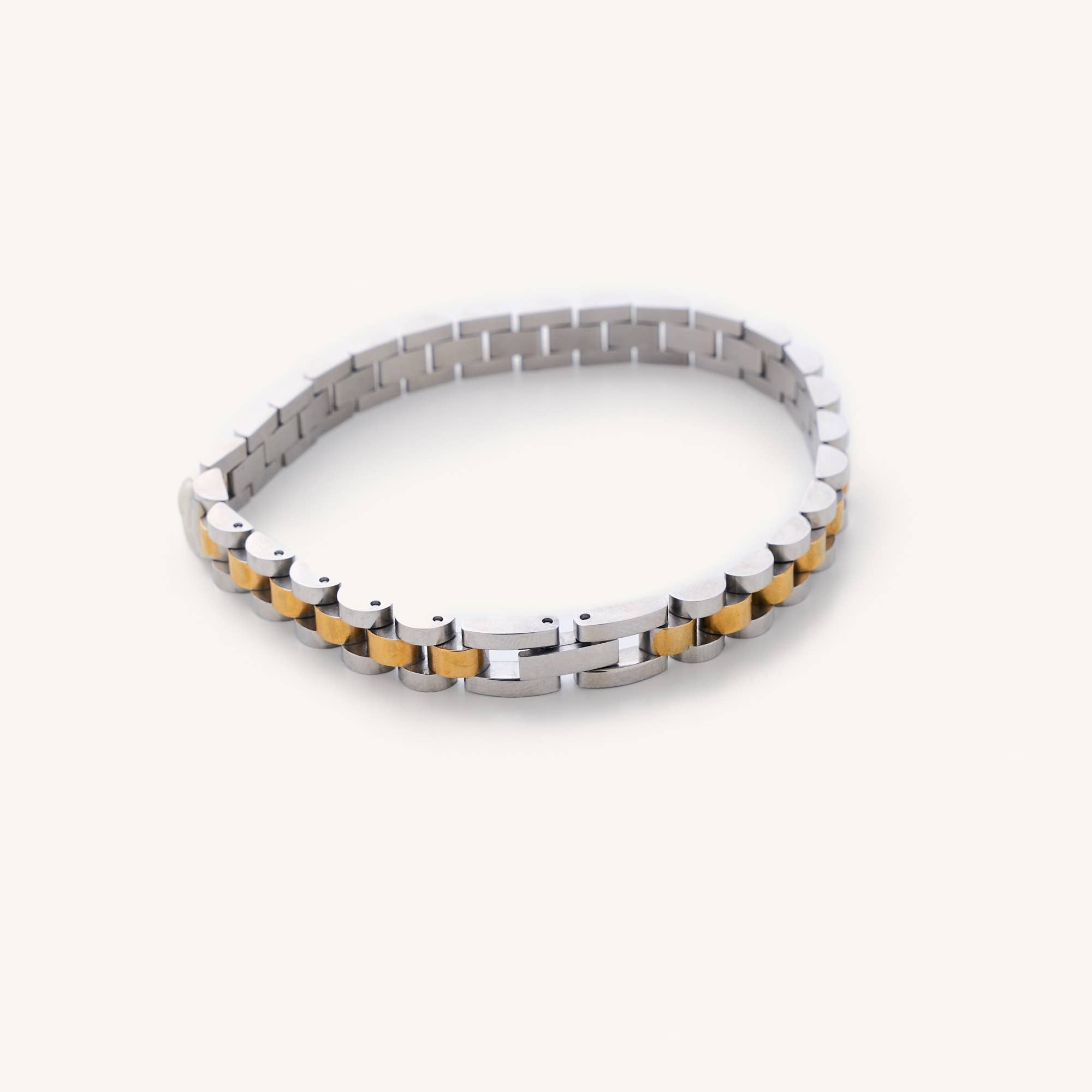 Waterproof silver and gold Cuban Link 6" plus a 2" extender laying on white background 