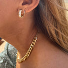 Woman wearing Gold diamond hoop earrings  
