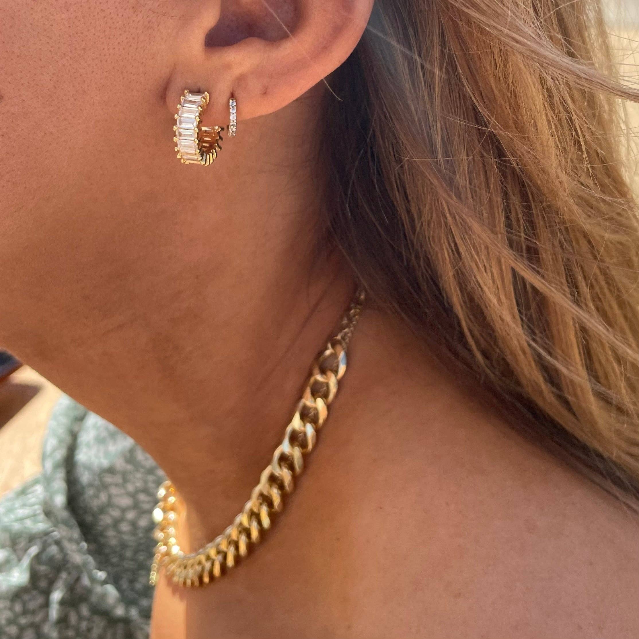 Woman wearing Gold diamond hoop earrings  