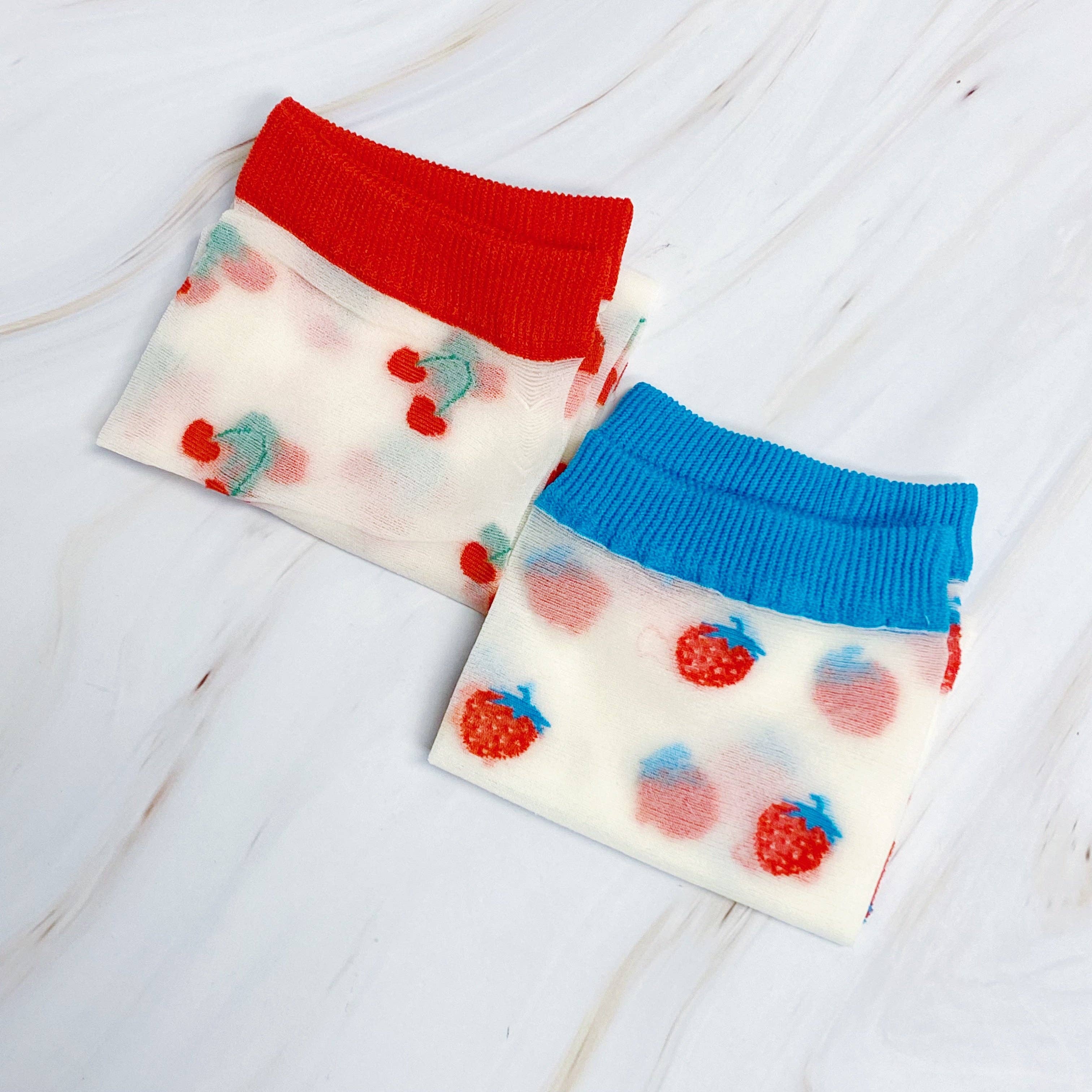 Two small pouches with colorful tops on a light wooden surface