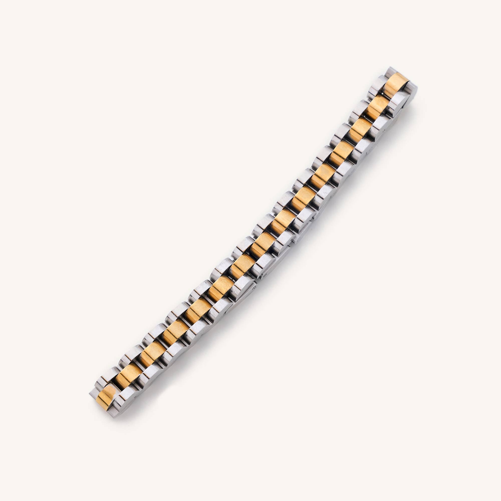 Waterproof silver and gold Cuban Link 6" plus a 2" extender laying on white background 