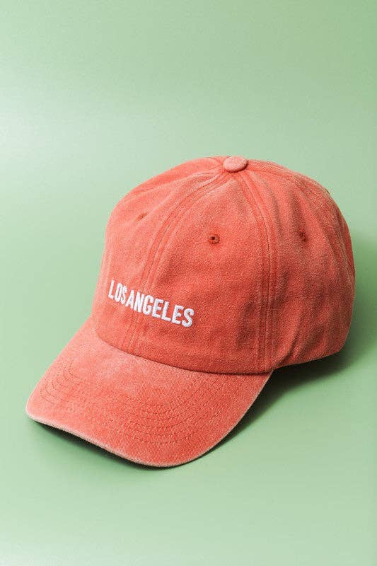 Red cap with 'Los Angeles' text on a green background