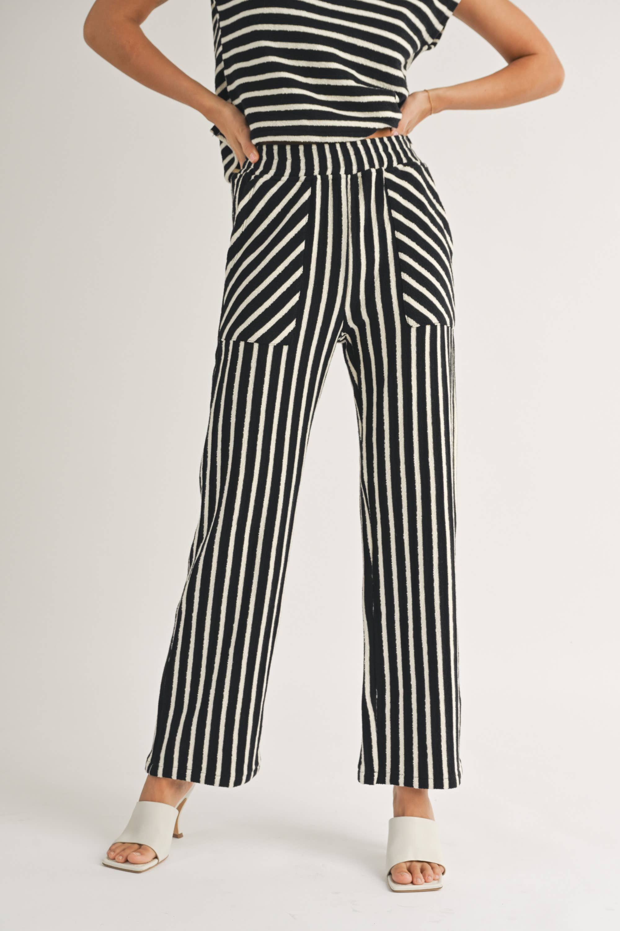 woman wearing Textured vertical Stripe Knitted Pants with contrasting stripes in the front pockets made of 100% Cotton