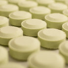 Green eucalyptus shower tablets lined up in rows on a flat surface