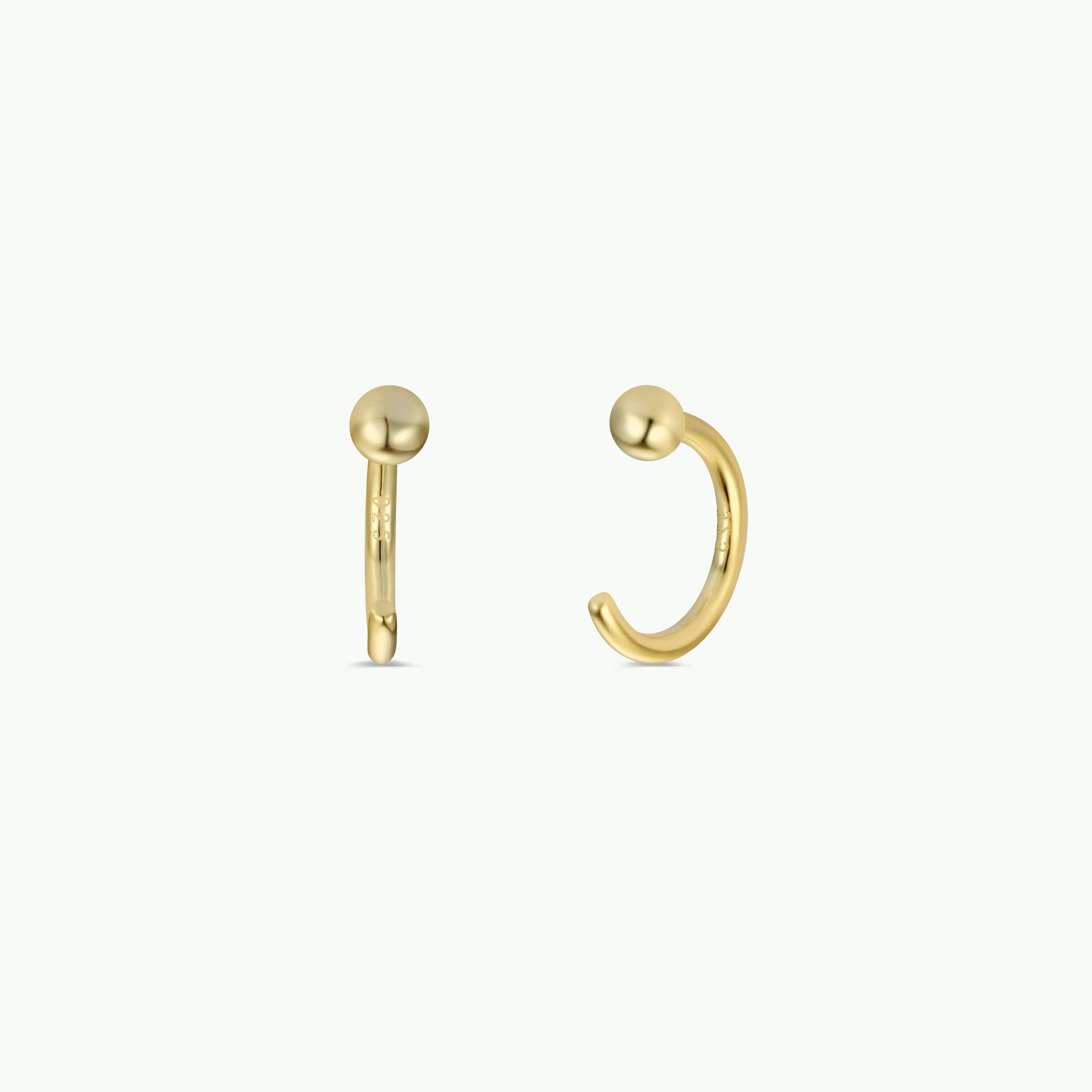 Gold hoop earrings on a white background