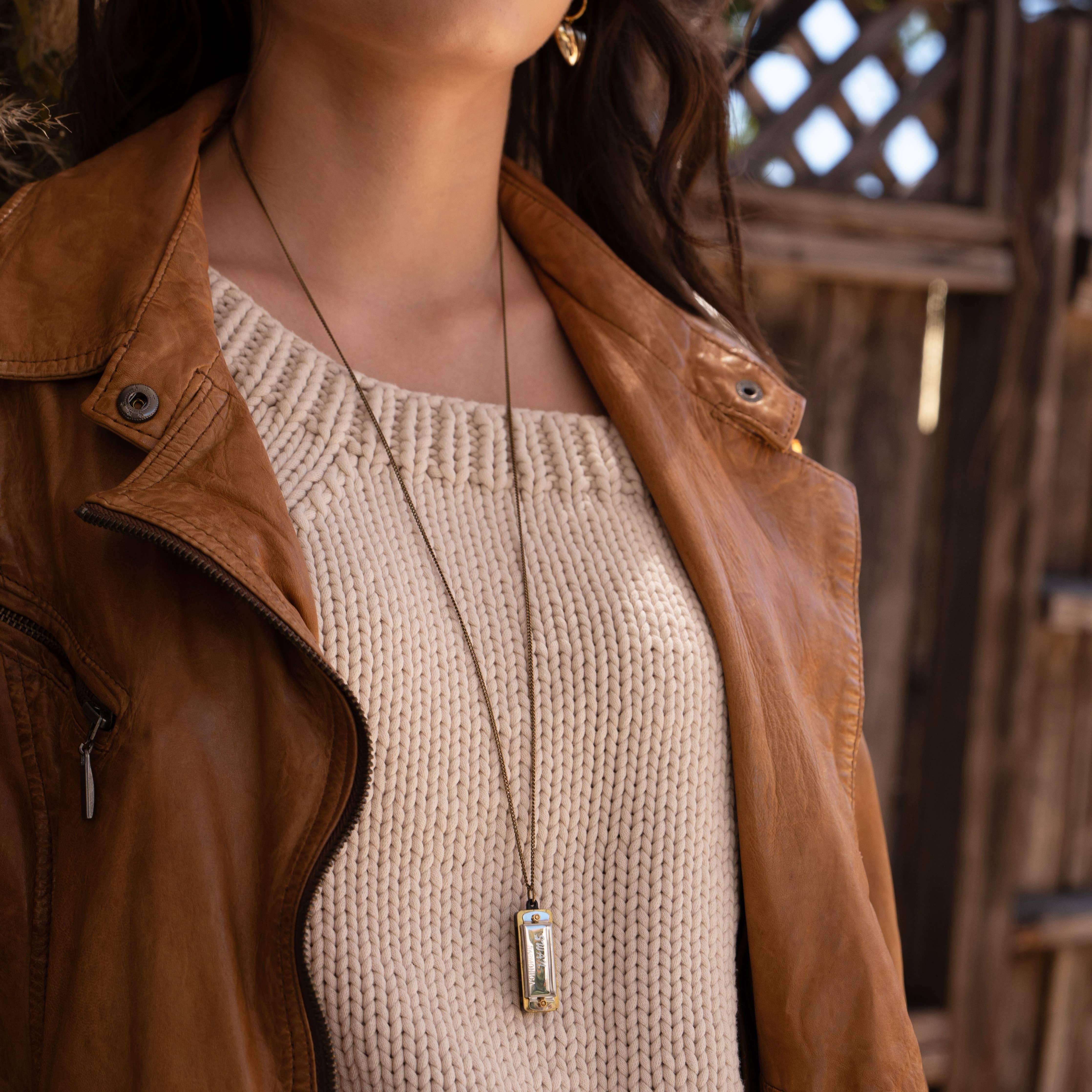 Woman wearing silver working swan harmonica necklace