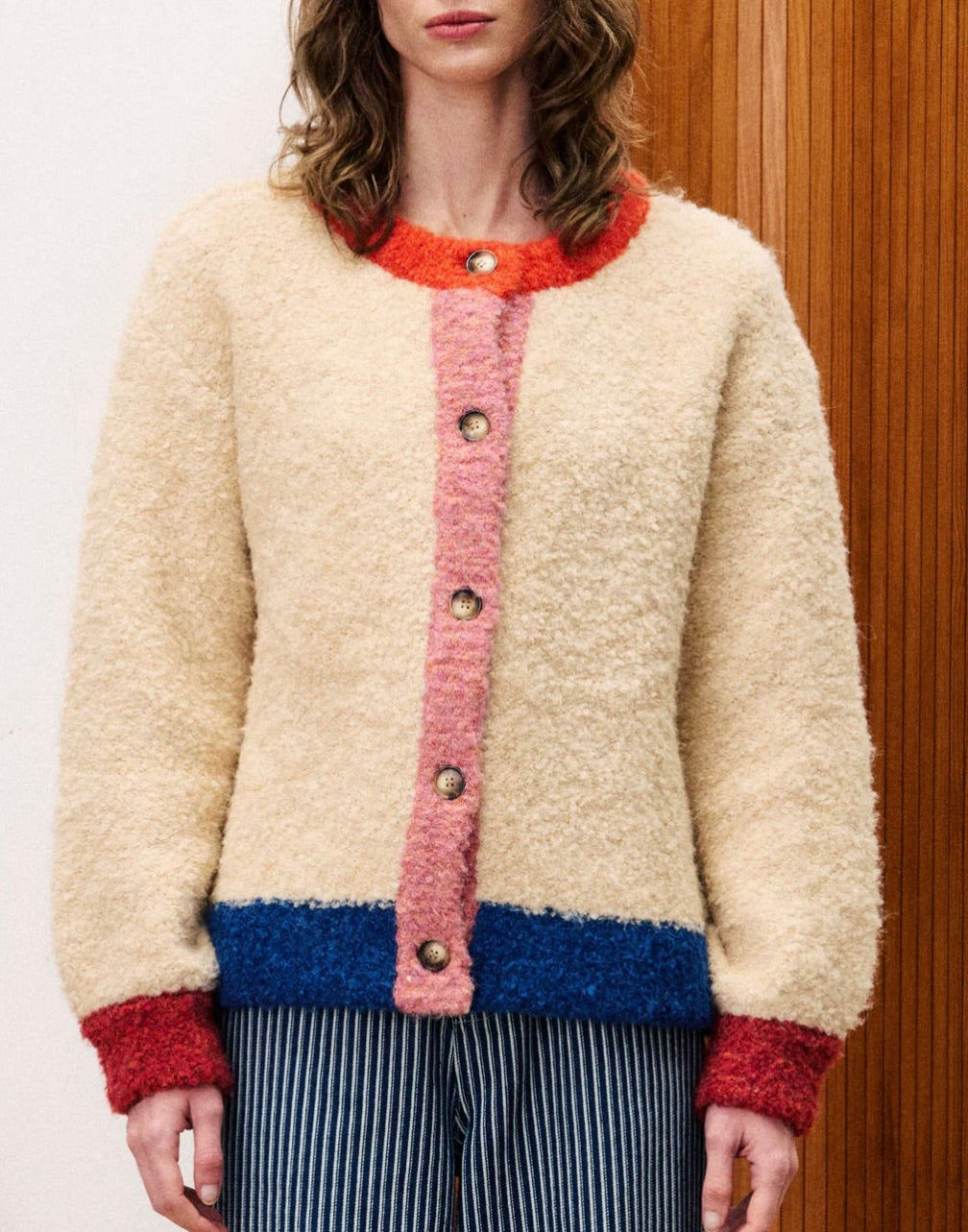 Person wearing a colorful knitted cardigan