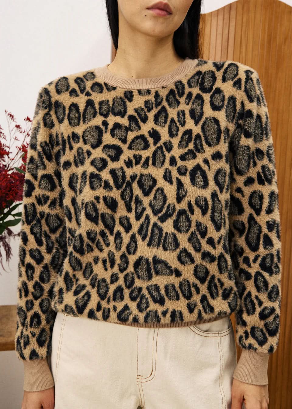 Person wearing a leopard print sweater 