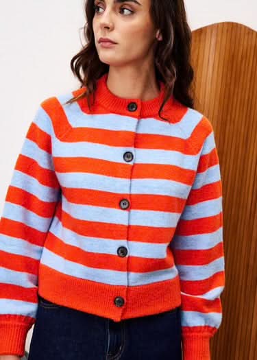 Person wearing a red and white striped sweater with buttons.