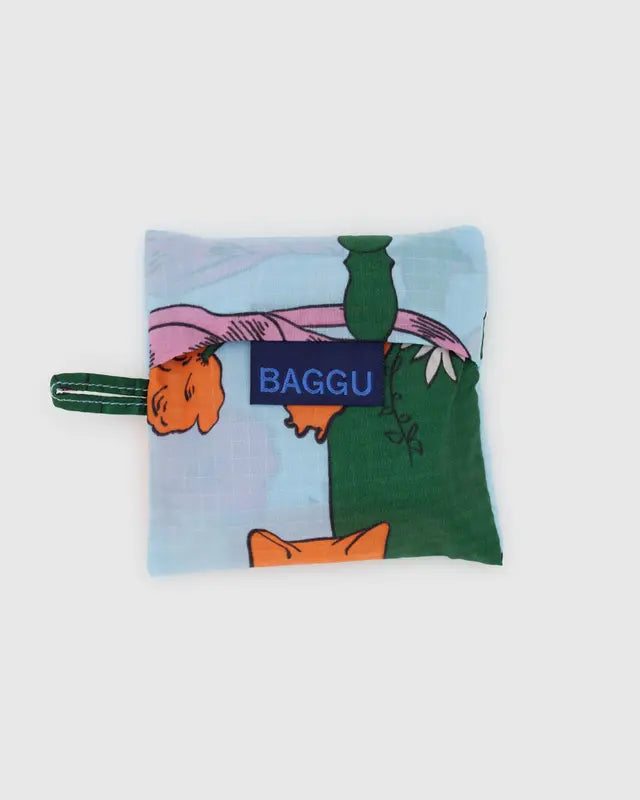 BAGGU reuse-able light blue bag design with big colorful and nature flowers, folded, on white background 