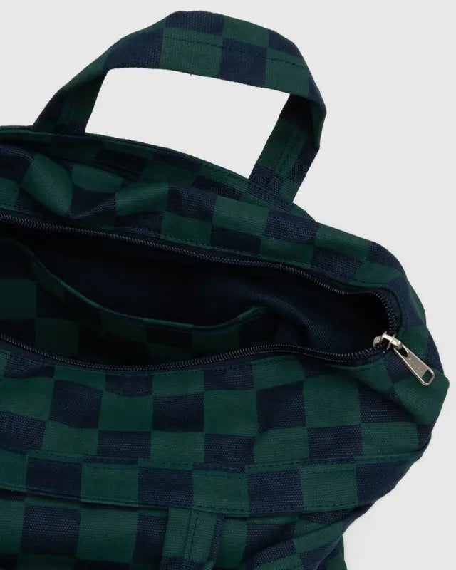 Inside details of BAGGU square navy and green checkered tote bag with handles and adjustable straps on white background 