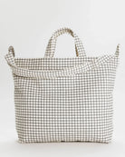 BAGGU on white background. BAGGU bag is a square tote bag with adjustable strap with white with black grid line design 